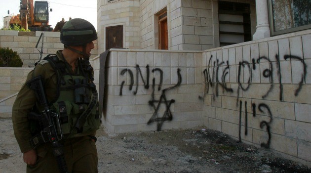 Israeli soldier walks past a mosque that was attacked by suspected Jewish extremists on the occupied West Bank. Read more: http://forward.com/articles/215446/west-bank-mosque-torched-by-price-tag-extremists-o/#ixzz3SnpxP5S8