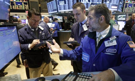 Specialist Anthony Rinaldi, right, works at his post on the floor of the New York Stock Exchange, Friday, Oct. 31, 2014 (Photo: AP)