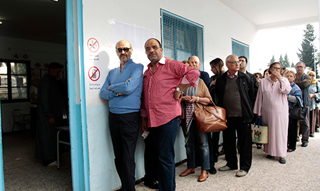 People wait in line outside a polling station to vote in Tunis November 23, 2014. (PHOTO: REUTERS)