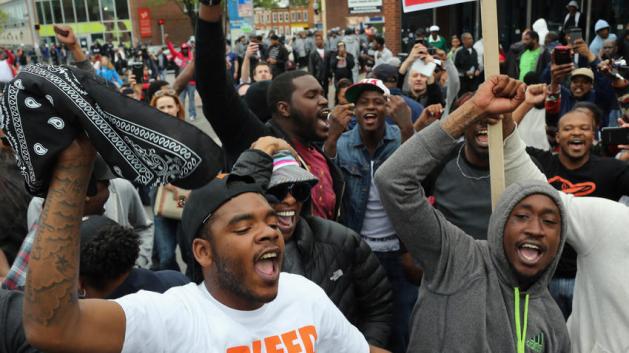 People celebrate after Baltimore authorities said there would be criminal charges against police in death of Freddie Gray. Win McNamee, Getty Images