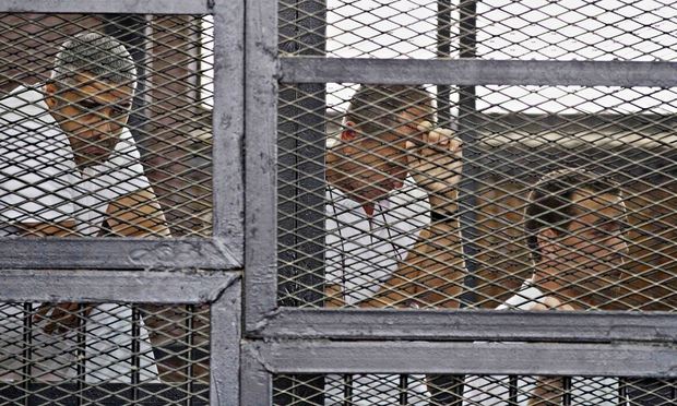  From left, Mohammed Fahmy, Canadian-Egyptian acting bureau chief of Al-Jazeera, Australian correspondent Peter Greste, and Egyptian producer Baher Mohamed in a Cairo court. Photograph: Hamada Elrasam/AP 