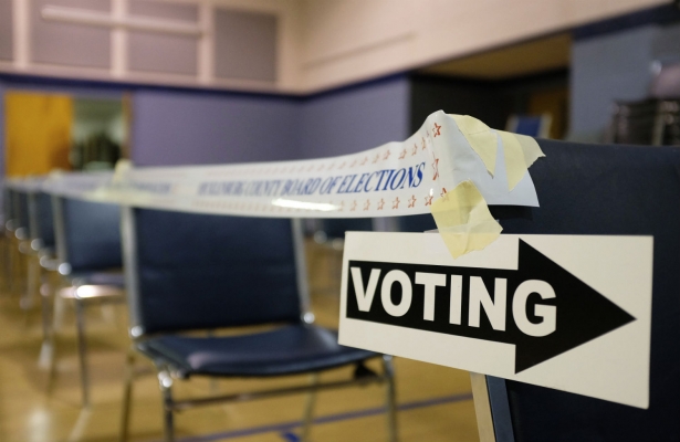 A voting sign directing voters is seen before polls open at the Grove Presbyterian Church in Charlotte, North Carolina, November 4, 2014. (Reuters/Chris Keane)