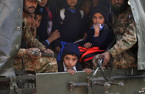 Pakistani soldiers transport rescued school children from the site of an attack by Taliban gunmen on a school in Peshawar, Dec. 16, 2014.