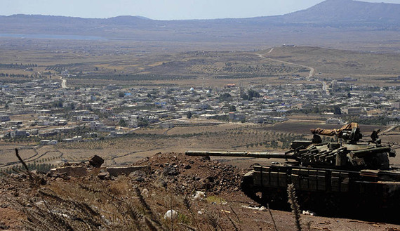 A tank belonging to forces loyal to Syria's President Assad is seen in the Quneitra city countryside during a battle with rebels
