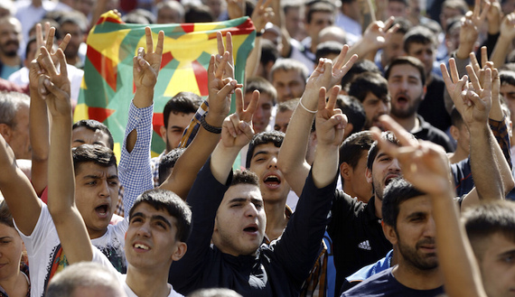 Kurdish demonstrators gesture as Selahattin Demirtas, co-chair of the HDP, Turkey's leading Kurdish party, addresses a crowd in Diyarbakir October 9, 2014. A three-week battle for the Syrian border town of Kobani has also led to the worst streets clashes in years between police and Kurdish protesters across the frontier in southeast Turkey. In Diyarbakir, Turkey's biggest Kurdish city, five people were killed in clashes on Monday and Tuesday between Islamist groups and PKK supporters, a senior police officer said.   REUTERS/Osman Orsal (TURKEY - Tags: POLITICS CIVIL UNREST) - RTR49ICE