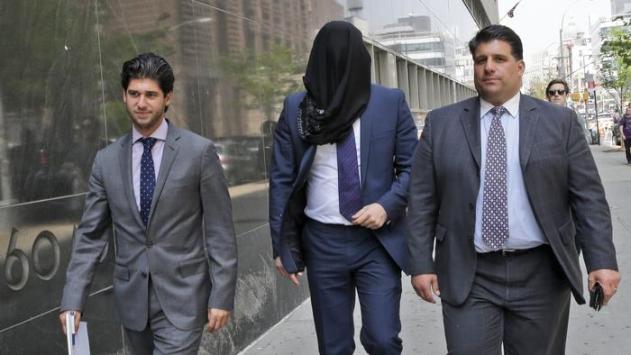 Wojciech Braszczok is led into the court with his face covered Tuesday in New York. (Mary Altaffer / Associated Press)