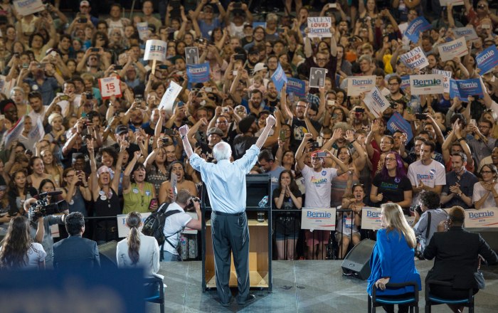  Democratic presidential candidate Senator Bernie Sanders lifts his arms in celebration as he speaks at a rally on August 9, 2015, in Portland. (AP Photo/Troy Wayrynen)
