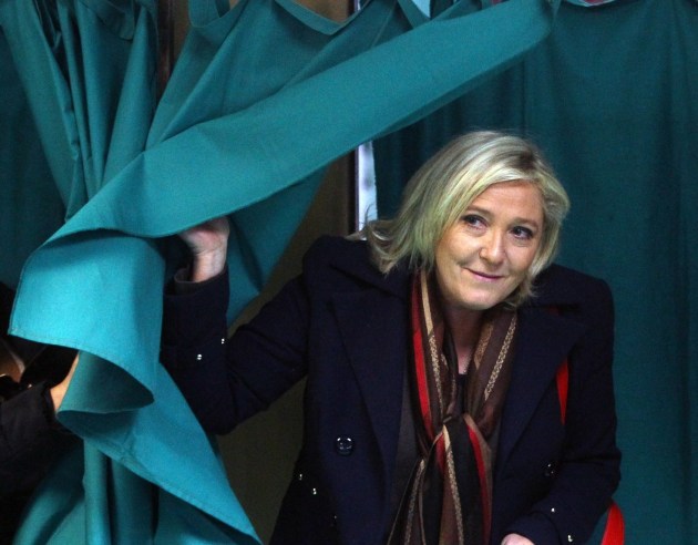  Marine Le Pen, leader of the French far-right National Front party, exits a polling booth during the second round of regional elections in Henin-Beaumont, northern France. (Michel Spingler/AP) 