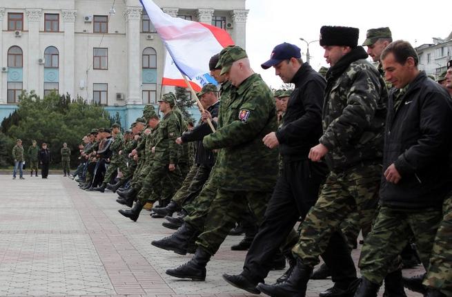 Russian soldiers and pro-Russian volunteers during a military parade rehearsal in preparation for the Victory Day parade in Simferopol, Crimea, on April 12, 2014. (AFP/Yuri Lashov)