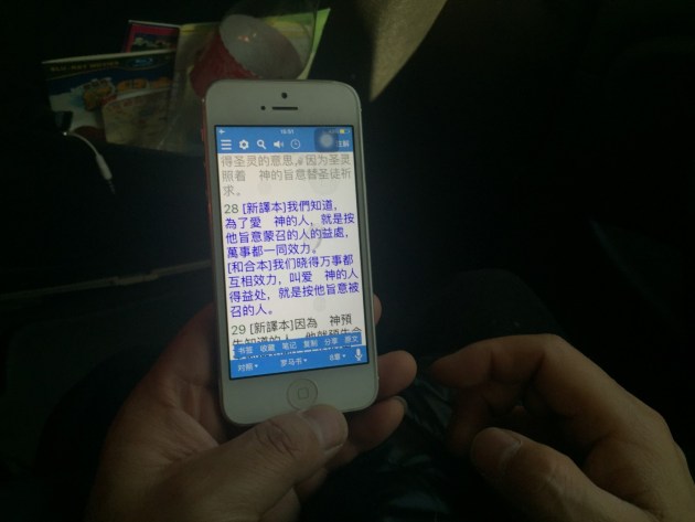  Pastor Su Tianfu, a Protestant preacher from Guiyang, China, reads the Bible on his iPhone. His church was recently shuttered in a sweeping government crackdown. (Emily Rauhala/The Post) 