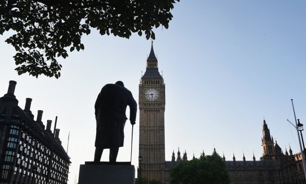  The sun rises over the the statue of Winston Churchill and the Houses of Parliament as votes are counted. Photograph: Mary Turner/Getty Images 