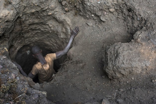 A “creuseur” descends into a tunnel at the mine in Kawama. The tunnels are dug with hand tools and burrow deep underground.