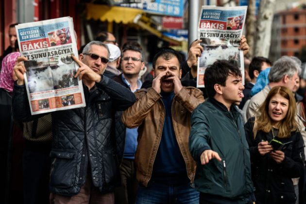 Protesters hold up a new newspaper by the former team of Zaman called "Yarina Bakis" ("Look to tomorrow") during a demonstration near the headquarters of the newspaper Zaman in Istanbul on March 6, 2016. Turkish police on March 4 raided the Istanbul premises of the Zaman newspaper using tear gas and water cannon to enter the building in order to impose a court order placing the media business under administration. The front page of the paper, normally strongly critical of the president, on March 6 was full of articles supporting the government. / AFP / OZAN KOSE (Photo credit should read OZAN KOSE/AFP/Getty Images)